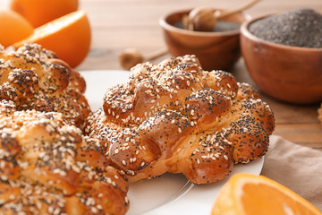 Tasty buns with poppy seeds on table, closeup