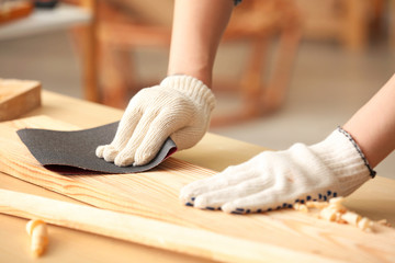 Female carpenter working in shop, closeup