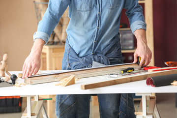 Male carpenter working in shop
