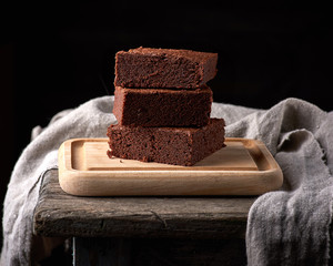 stack of baked square pieces of chocolate brownie cake