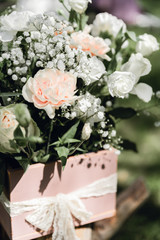 Blooming decoration of wedding arch with roses, carnation and eucalyptus. Beautiful wedding ceremony outdoors. White and pink colors. Wedding photo zone. Floral concept. Wedding details