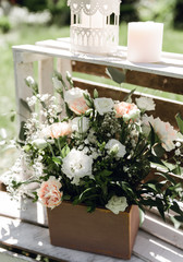 Blooming decoration of wedding arch with roses, carnation and eucalyptus. Beautiful wedding ceremony outdoors. White and pink colors. Wedding photo zone. Floral concept. Wedding details