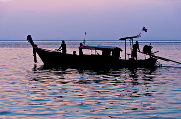 Long tail asian boat. Sea on sunset. Dawn Indian ocean. Seascape and mountains