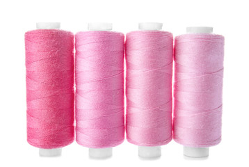Colorful sewing threads on white background