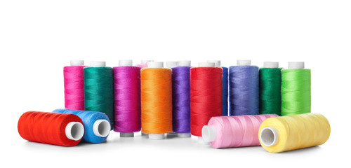 Colorful sewing threads on white background