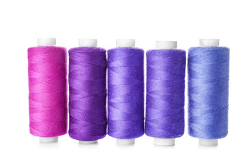 Colorful sewing threads on white background