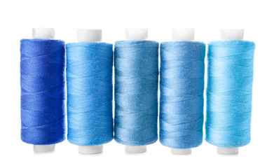 Colorful sewing threads on white background