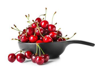 Pan with sweet ripe cherry on white background