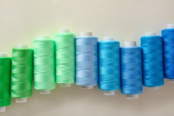 Colorful sewing threads on light background