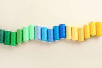 Colorful sewing threads on light background