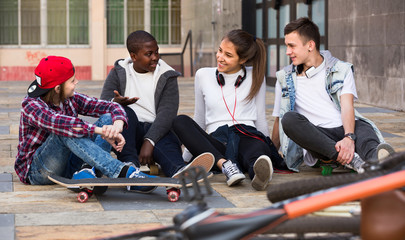 teens chatting near bikes