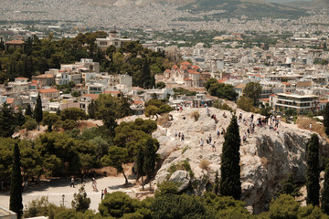 Fototapeta na wymiar tourists walking in the ancient area near Acropolis in a sunny day in the capital of Greece JUNE 2019 - Athens.