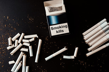 Broken cigarettes. Dangerous habit. Harmful for health. Smoking kills.