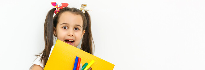 Portrait of smiling school girl child with backpack and books isolated on a white background