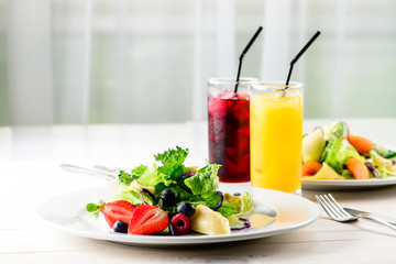 Fresh Blueberries, Cranberry salad with arugula, nuts, feta cheese, olive oil, herbs. Morning, breakfast healthy food.