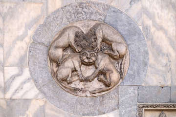 Byzantine mythical creature with four bodies sharing a single head, executed in marble, wall of the basilica of St Mark's, Piazza San Marco, Venice, Italy