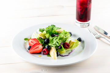 Fresh Blueberries, Cranberry salad with arugula, nuts, feta cheese, olive oil, herbs. Morning, breakfast healthy food.