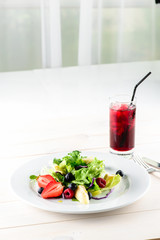 Fresh Blueberries, Cranberry salad with arugula, nuts, feta cheese, olive oil, herbs. Morning, breakfast healthy food.