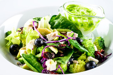 summer salad with avocado, strawberries and spinach, close up