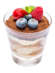 Classic tiramisu dessert with blueberries and raspberries in a glass isolated on a white background with clipping path