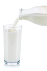 Fresh milk pouring pour glass bottle isolated on white