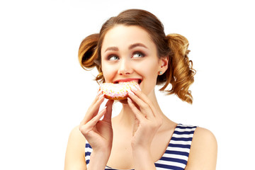 A beautiful girl with a stylish hairstyle bites a donut and closes her eyes with pleasure. The concept of sweets, junk food and a quick snack. Large isolated portrait on white background