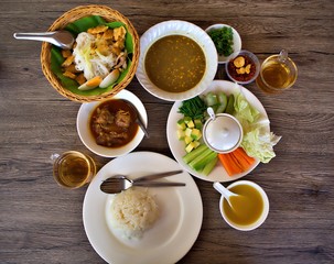 A set of myanmar dish on the wooden table. Dishes are Myanmar(Burmese) style noodle (MonHinGa),...