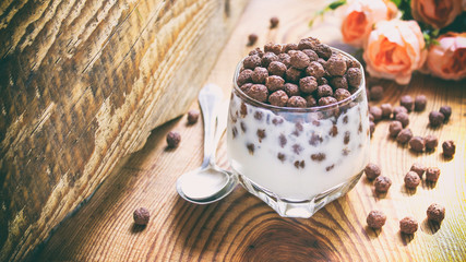 chocolate multislake balls with milk in a glass. delicious sweet breakfast