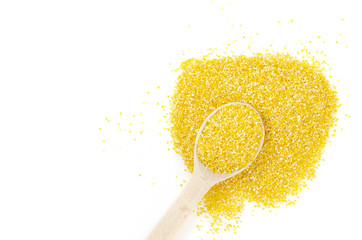 Bright corn grits with a wooden spoon are on a white background