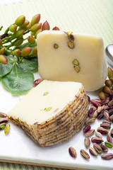 Italian provolone or provola cheese made in Sicily with tasty green Bronte pistachio nuts served on...