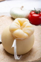 Italian provolone or provola caciocavallo hard cheese in teardrop form served on old paper close up