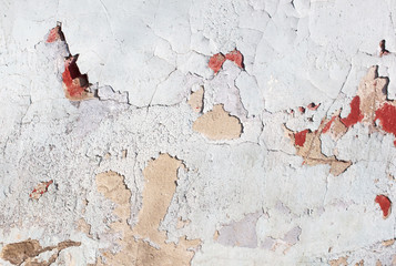 Concrete wall with cracked paint as abstract background