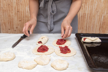 The hostess prepares the pies in the kitchen