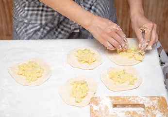 The hostess prepares the pies in the kitchen