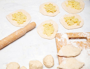 The hostess prepares the pies in the kitchen
