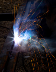 Sparks from welding at a construction site as a background