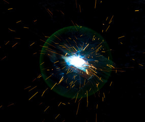 Sparks from welding at a construction site as a background
