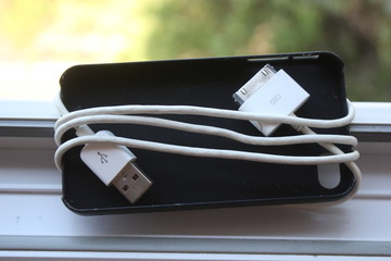 White wire coiled around the black cover.