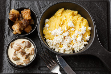 Typical Ukrainian dish polenta - Banosh with cheese and lard. Ukrainian cuisine. maize porridge...
