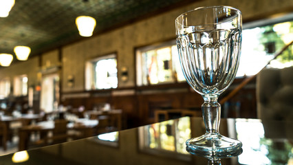 Glass on the bar. Sunny restaurant. Dishes in cafe.