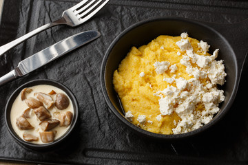 Typical Ukrainian dish polenta - Banosh with cheese and lard. Ukrainian cuisine. maize porridge...