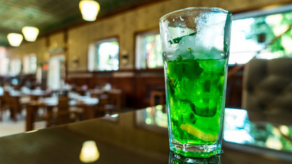 Cold drink. Cocktail on the bar. Sunny restaurant.