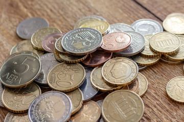 coins old and new Europe euro pile pack heap on a wooden background mock up selective focus close up