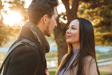 Fototapeta premium Beautiful loving couple posing walking outdoors in park nature.
