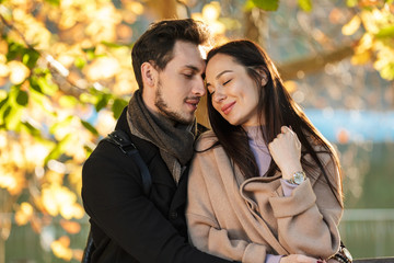 Young beautiful loving couple posing walking outdoors in park nature.