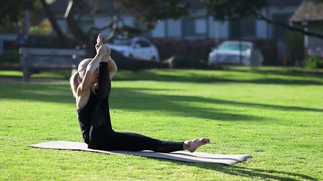 Young blonde woman is doing yoga exercises