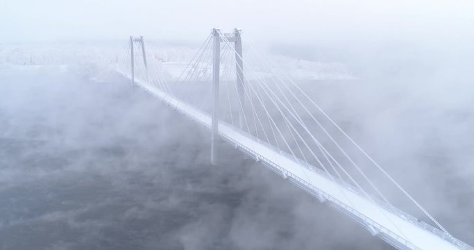 Bridge across the Yenisei river in fog. Mist over cable-stayed bridge in Krasnoyarsk.