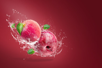 Water splashing on Fresh Red apple on red background