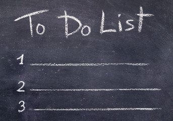 Handwriting to do list with chalk on black board background
