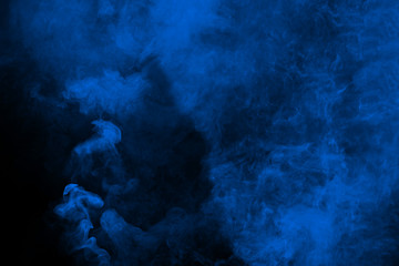 Fototapeta na wymiar Abstract blue smoke on black background. Blue color clouds.